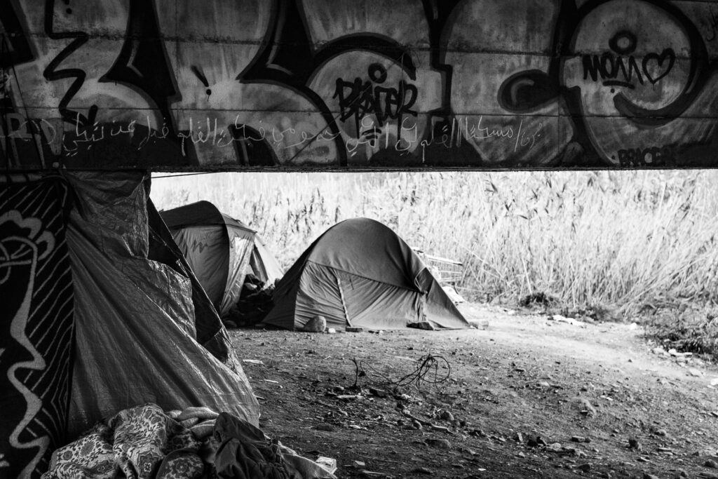 The camp is a place of both despair and hope, violence and solidarity, embodying the ambivalence of the migration issue.