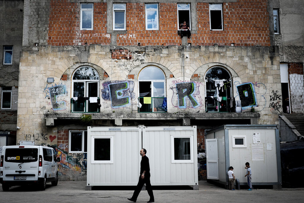 The unfinished Borici student dormitory stands above the NK Jedinstvo football stadium and hosts families and unaccompanied minors. I am not allowed to bring my camera inside. Borici refugees camp, Bihac, Bosnia Herzegovina, 2019.