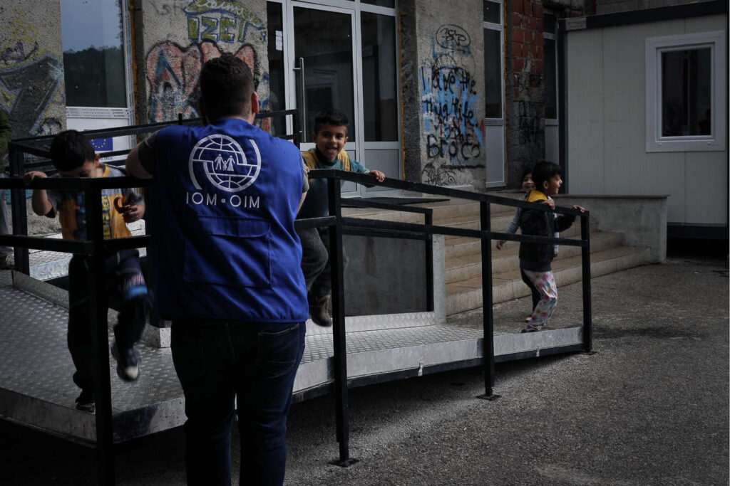 A violent downpour forces me and the escort I have been “assigned” to take shelter under a roof, while the children, unfazed by the rain and everything else, play by chasing each other as if they were refugees and police. The game of pushback. Bihać, Bosnia and Herzegovina, 2019.