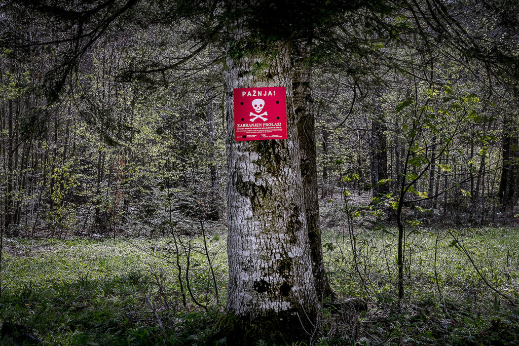 “Attention! No entry! Entering a mine-risk area is a punishable offence!” reads a sign in Croatian attached to a tree in the forest. It is one of the reasons why the migration route through this forest is called “the game.” Not only law enforcement pushing people back to the starting point, but also landmines, wolves, bears, and no way to orient oneself at night. Somewhere in the Croatian forest, 2019.