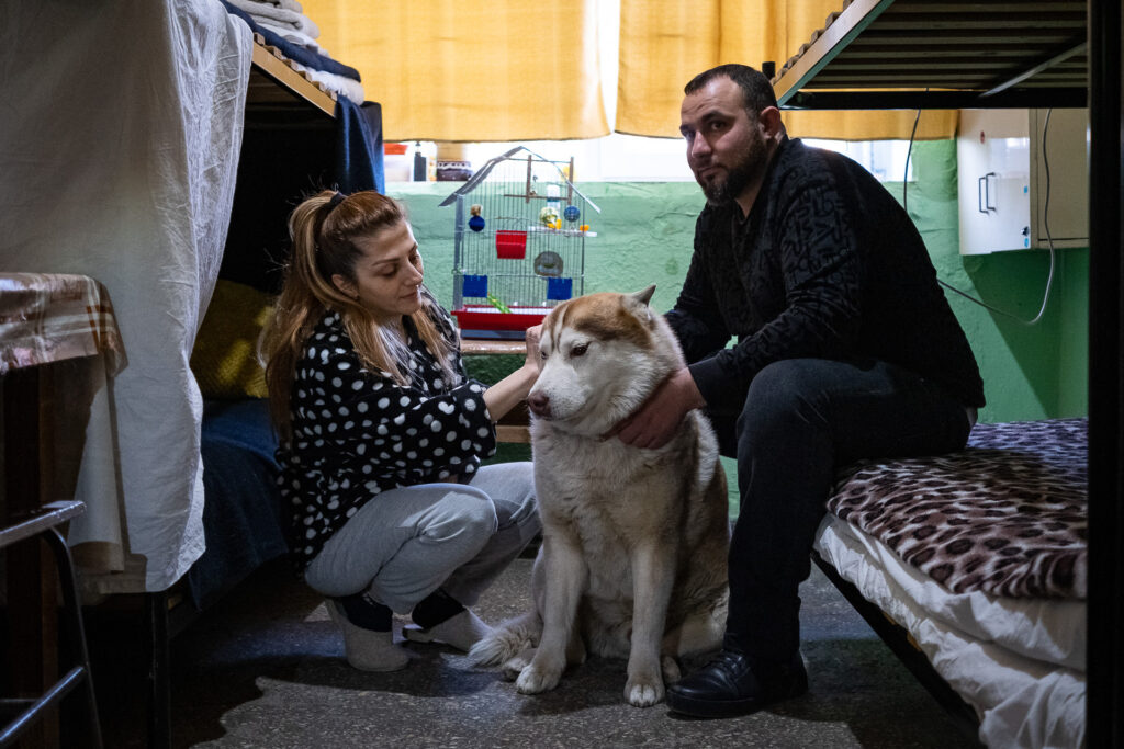 Angela and Levon cannot get married. They are Armenians and were already refugees in Ukraine, having fled the Nagorno-Karabakh war, which has continued intermittently since the 1990s. Levon no longer holds an Armenian passport and has been declared stateless; he still shows his Soviet-era document among his papers. For this reason, they cannot marry. They are staying in a military facility used to host refugees, with their dog and her trained parrot, until the situation stabilises. Chișinău, Moldova, March 21, 2022.