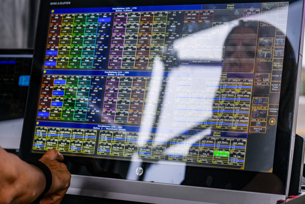 Federica, a lighting designer, tests the lighting system during setup for a music festival. Genoa, June 2022.