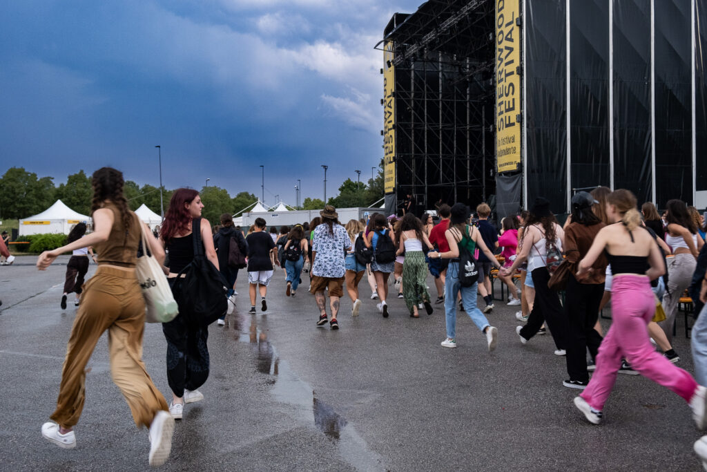 As soon as the gates open, the audience of Sherwood Festival in Padua runs toward the stage to secure a spot before the beginning of the show. Padua, July 2022.