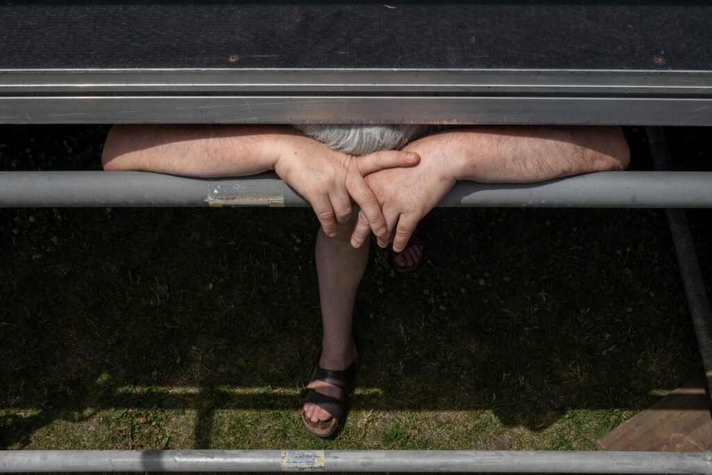 Totò, local promoter and producer of a festival, takes a moment to recover after learning that the artist scheduled to open the event will not perform due to an accident. As the person financially responsible for the festival, a postponed date could mean rebuilding the entire stage production or refunding all sold tickets. Genoa, June 2022.