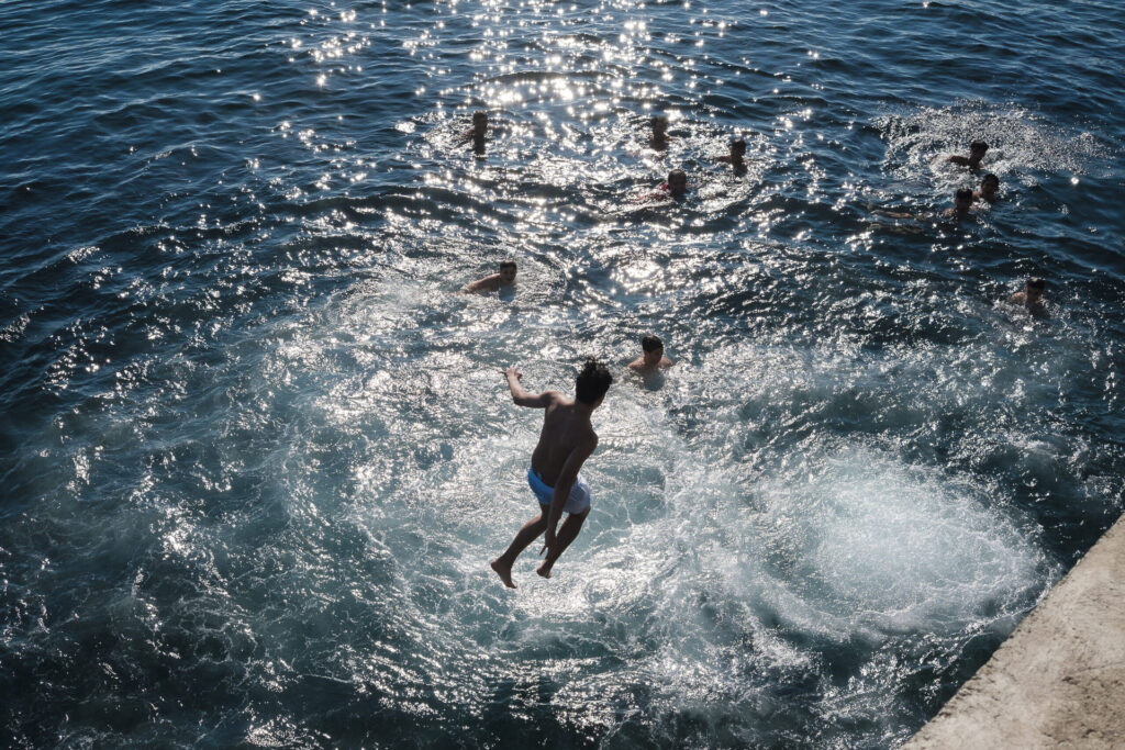 Kids dive from the Pier in the Quinto district. Genoa, June 2nd, 2020.